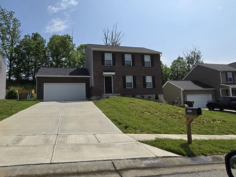 a house with a driveway and a parking meter